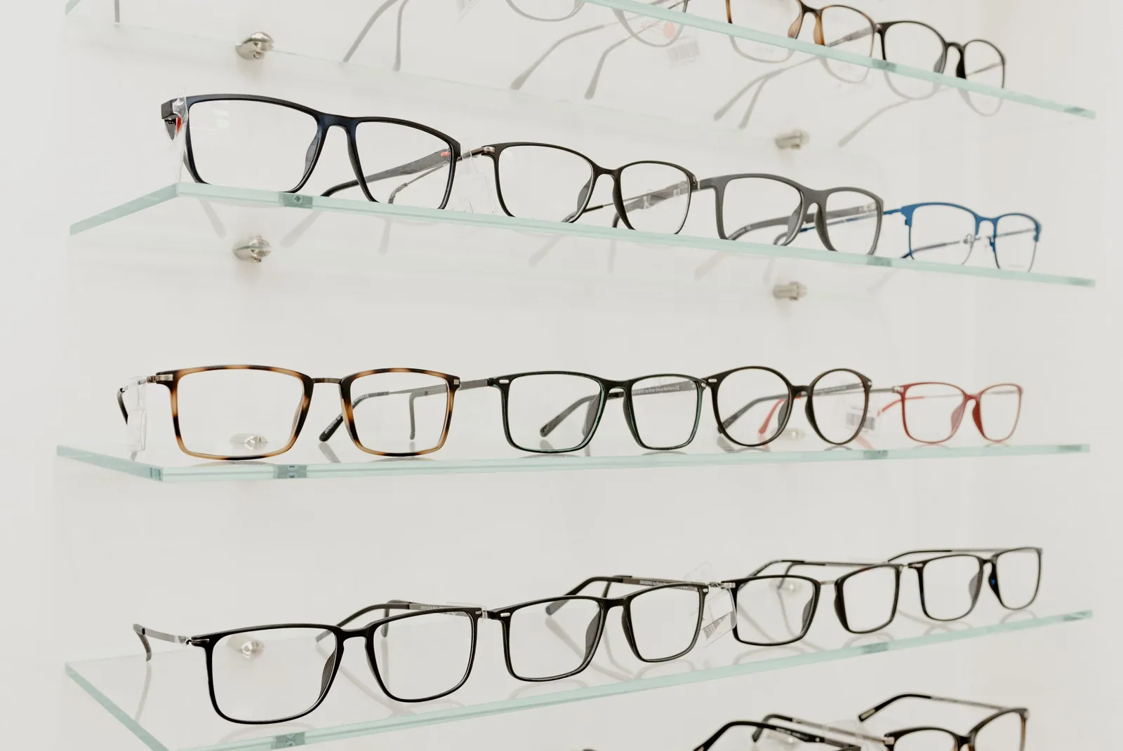 Rows of frames on glass shelves in the practice
